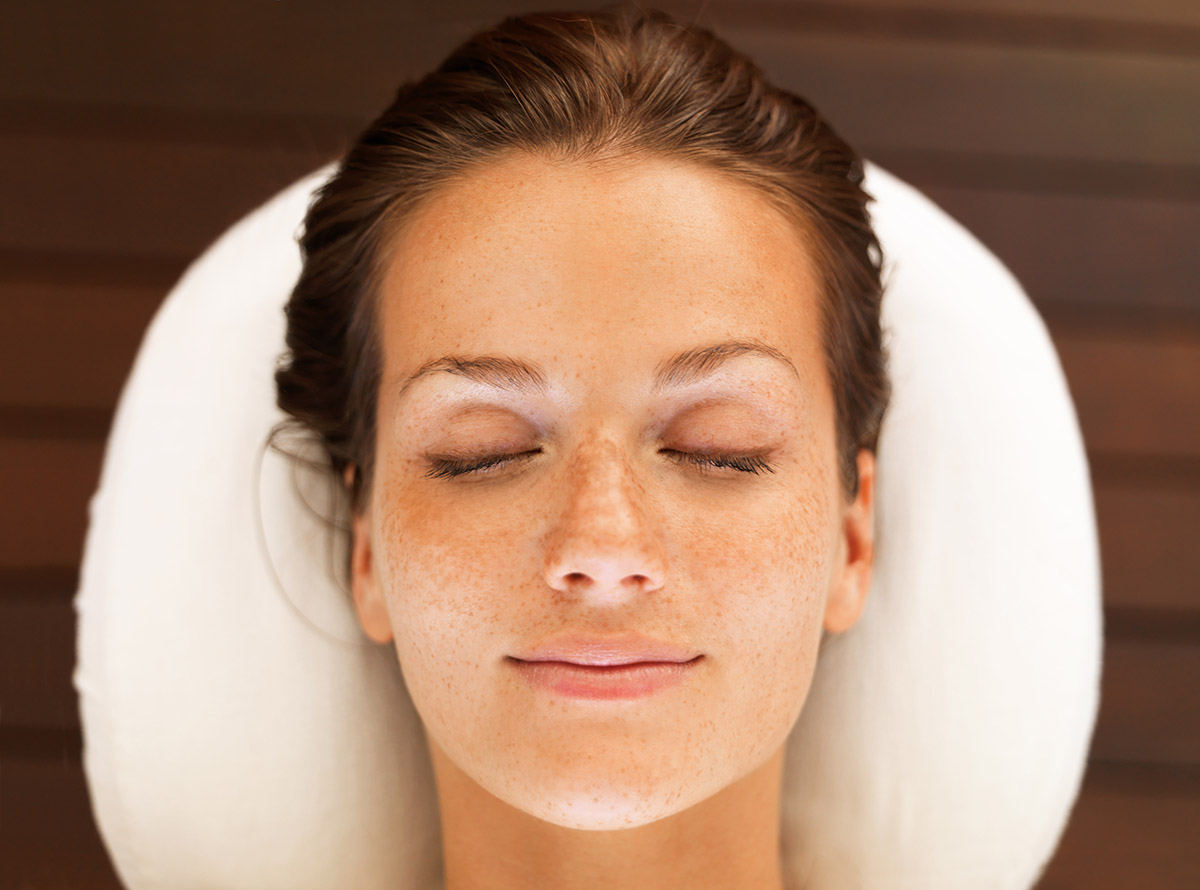 Relaxed woman with closed eyes enjoying a spa treatment.